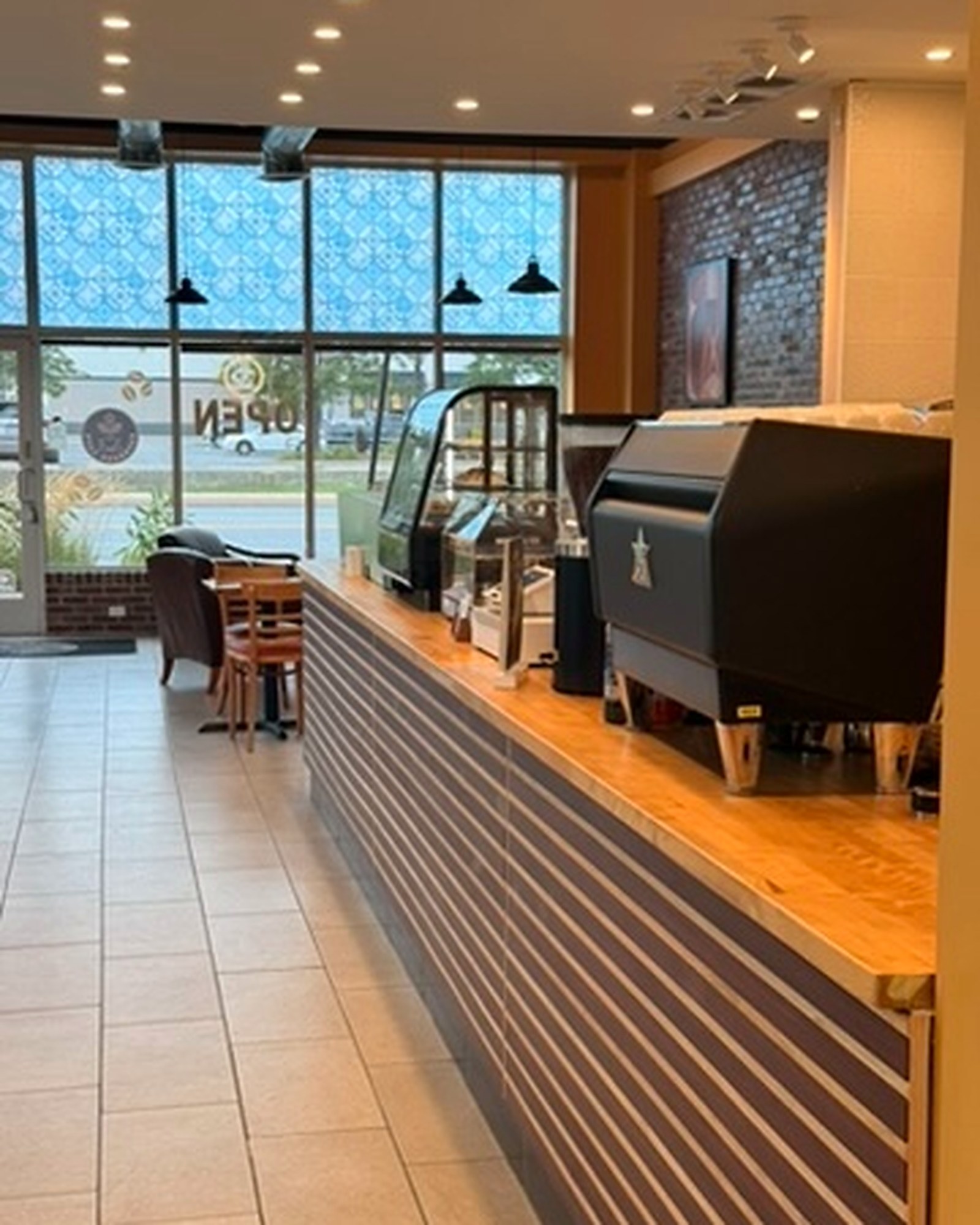 Inside Espresso Cafe: the counter, the espresso machine, and the pattern-glass front windows
